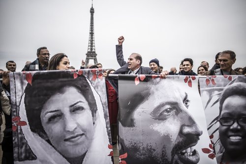 Activists gather outside the Palais de Chaillot for the closing ceremony of the Human Rights Defenders World Summit 2018