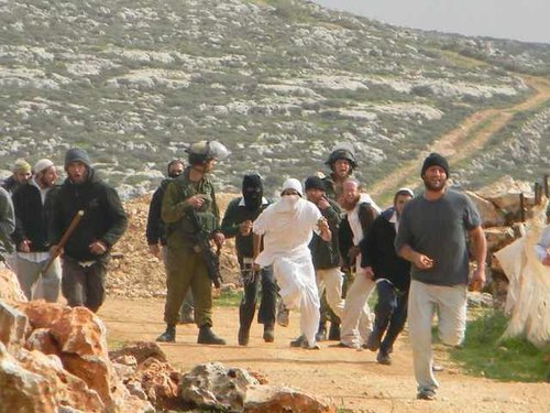 188315_soldiers_watching_while_israeli_settlers_attack_palestinians_and_t_PZ6hi9P.jpg