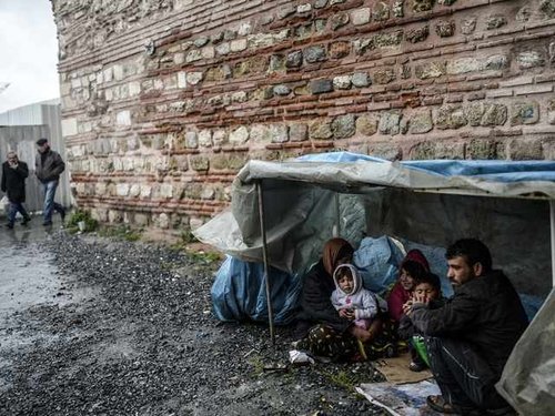 193756_a_syrian_refugee_family_from_aleppo_take_shelter_on_a_rainy_day_in_1cv3ZXu.jpg