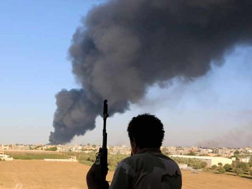 202267_a_fighter_from_zintan_brigade_watches_as_smoke_rises_after_rockets_AvMeBNw.jpg