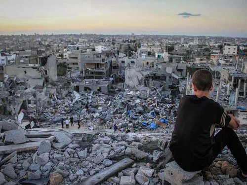 202472_a_palestinian_child_sits_above_the_ruins_of_his_ruined_home_2.jpg