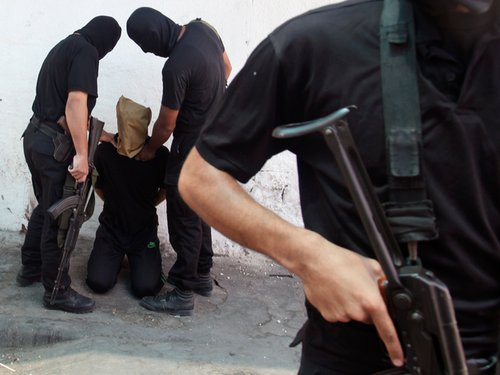 211162_hamas_militants_grab_a_palestinian_suspected_of_collaborating_with_9WVBrKK.jpg