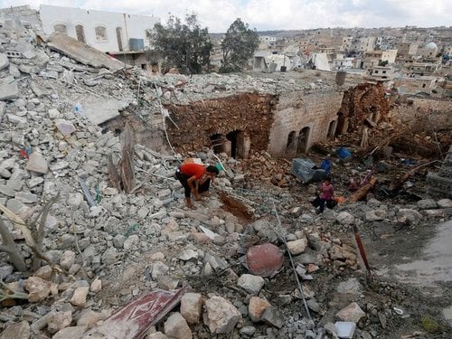 223529_civilians_inspect_a_site_hit_by_what_residents_said_were_airstrike_Bbin8cq.jpg