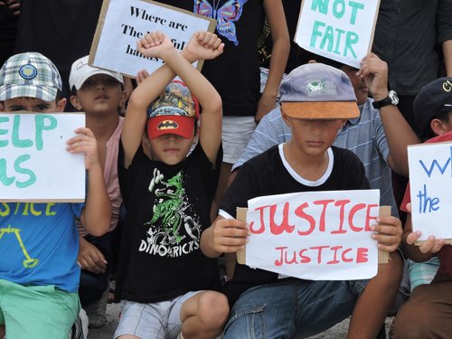 Refugee children take part in a protest in March 2015 against their resettlement on Nauru and living conditions on the island