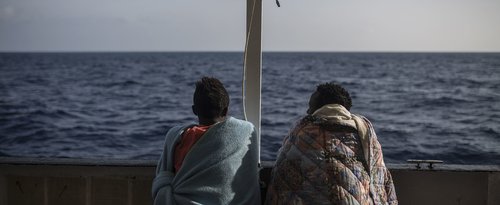 igrants look at the sea from the deck of the NGO Proactiva Open Arms boat on July 2, 2018