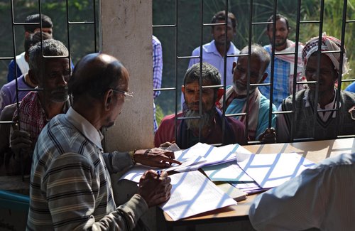 eople wait to check their names on the first draft of the National Register of Citizens (NRC) at Goroimari of Kamrup district in the Indian state of Assam on January 1, 2018
