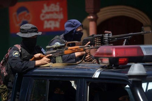 Members of the National Police armed with Dragunov riffle and a PKM machine gun in Masaya