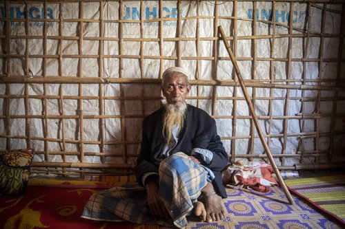 Abul Hossain, around 85 years old, sits in his shelter in Camp #1 West (Kutupalong Camp), Bangladesh, 19 February 2019
