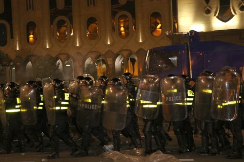Police take security measurements as protesters gather outside Georgia's parliament