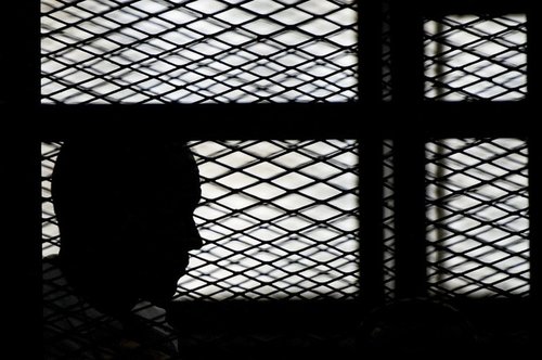 Silhouette of a prisoner in his cell