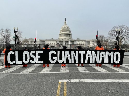 Activists in front of the Capitol Building in Washington hold a large banner that reads 'Close Guantanamo'