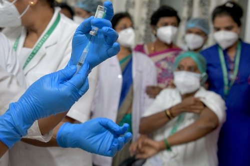 Picture of a doctor administering a vaccine to a patient
