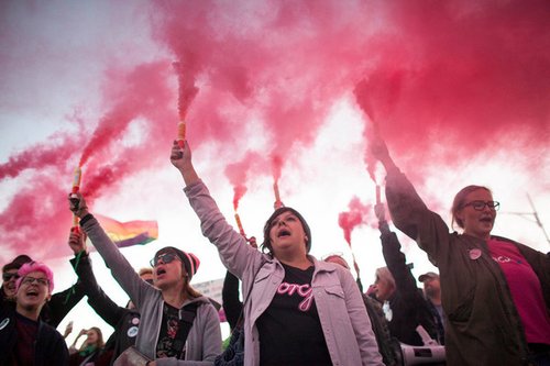 Protesters hold flares during Pro Choice March in Warsaw in 2018