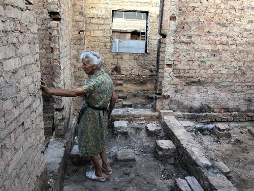 Hanna Selivon standing in her destroyed home in Chernihiv, Ukraine. July 2022