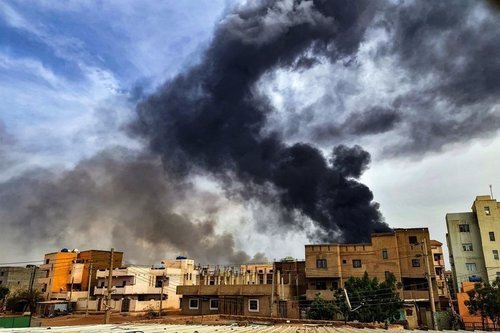 Smoke plumes billow from a fire at a lumber warehouse in southern Khartoum