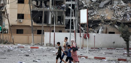 Family walking in the ruins of Gaza