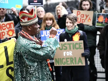 Activists and speakers - including King Okabi of the Ogale community - call for an end to Shell's pollution of the Niger Delta and compensation outside the Royal Courts of Justice in London, on day one of the Ogale and Bille communities vs Shell trial, 13
