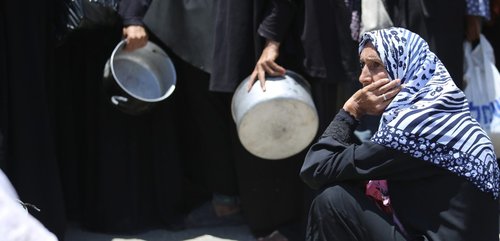 woman seeking aid in Gaza