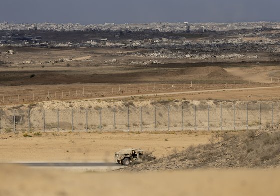 Israeli army vehicle moves near the border with the Gaza Strip
