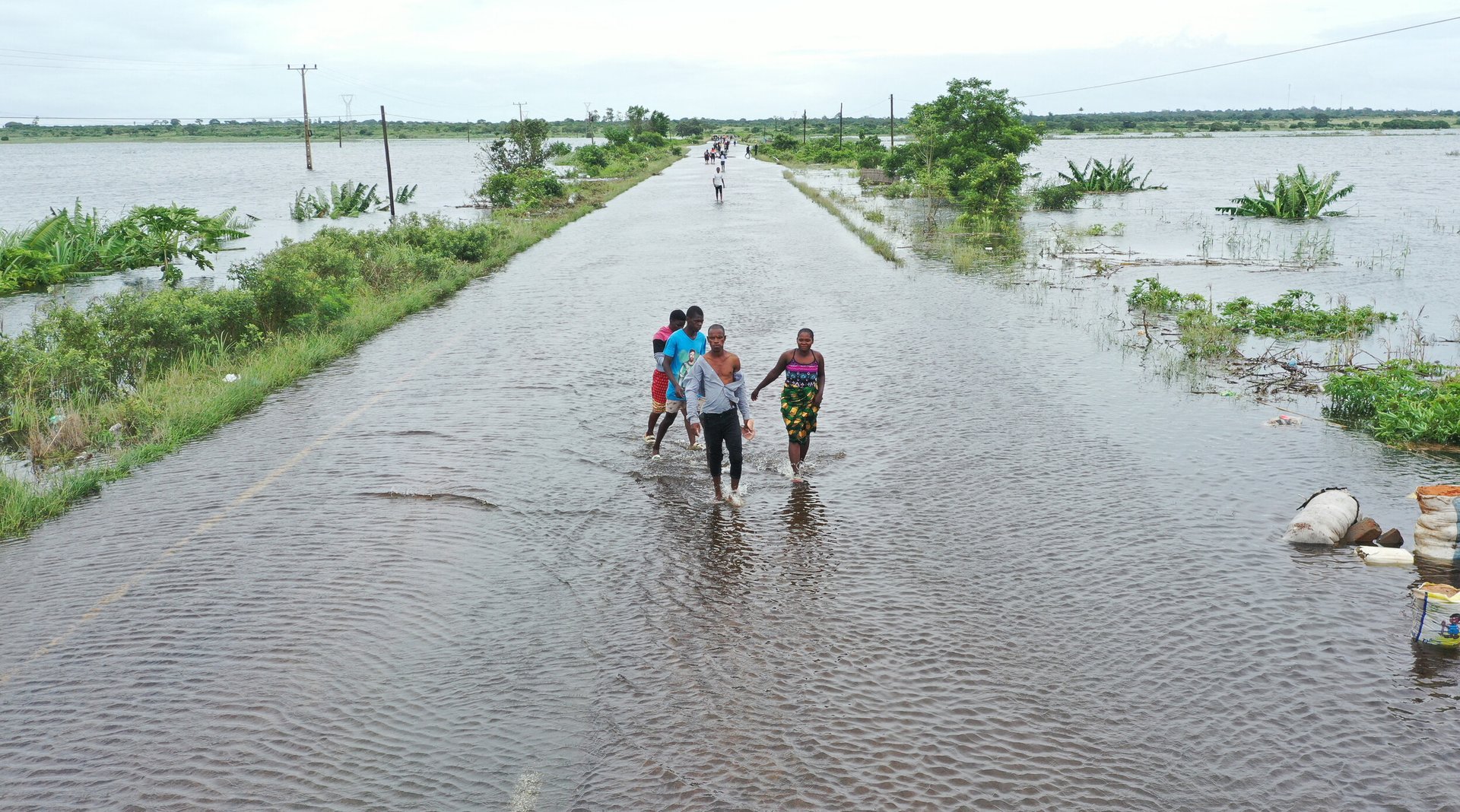 Aerial view shows residents wading through floodwater to cross a road near Maputo in Mozambique.