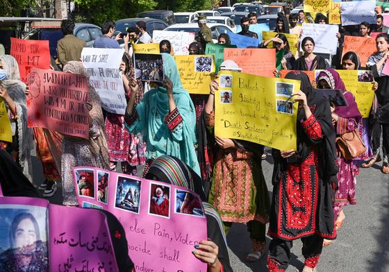 Activists from Baloch Students Council display banners as participate in a protest demanding the release of Mahrang Baloch, one of Pakistan's most prominent human rights advocates, along with missing Baloch persons, in Lahore on March 23, 2025.