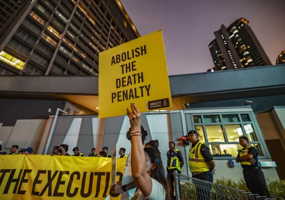 Amnesty International activists hold a banner in solidarity with Pannir Selvam, a Malaysian man awaiting execution for drug trafficking, outside Singapore's embassy in Kuala Lumpur, Malaysia, on May 6, 2025.