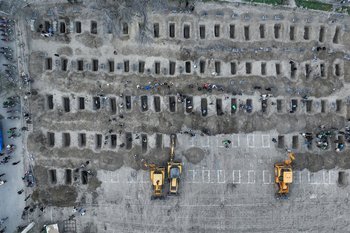In this aerial handout picture released by the Iranian Press Center, mourners dig graves during the funeral for children killed in a reported strike on a primary school in Iran's Hormozgan province in Minab on March 3, 2026.