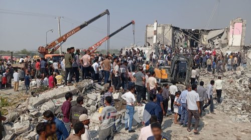 Picture shows the site of school strike. The distinctive pancaking of the roof is evidence of a top-down air strike which destroyed much of the school building.