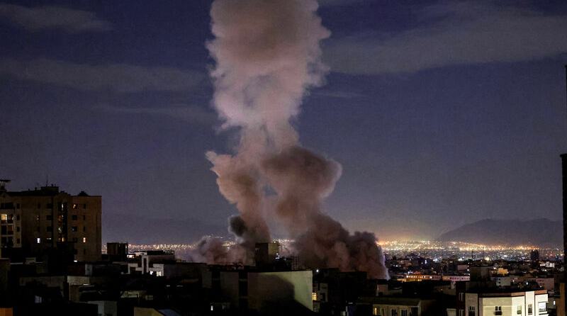 A smoke plume rises following a missile strike on a building in Tehran on March 1, 2026. (Photo by ATTA KENARE / AFP via Getty Images)