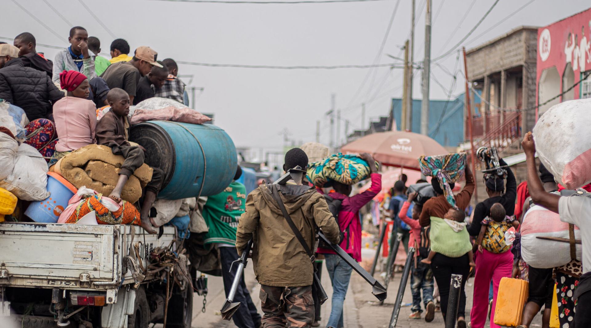 A Wazalendo (Patriots in Swahili) militiaman, part of a group of pro-government militias, retreats alongside residents as they flee from Kibati, where fighting has intensified, towards the city of Goma on January 26, 2025.