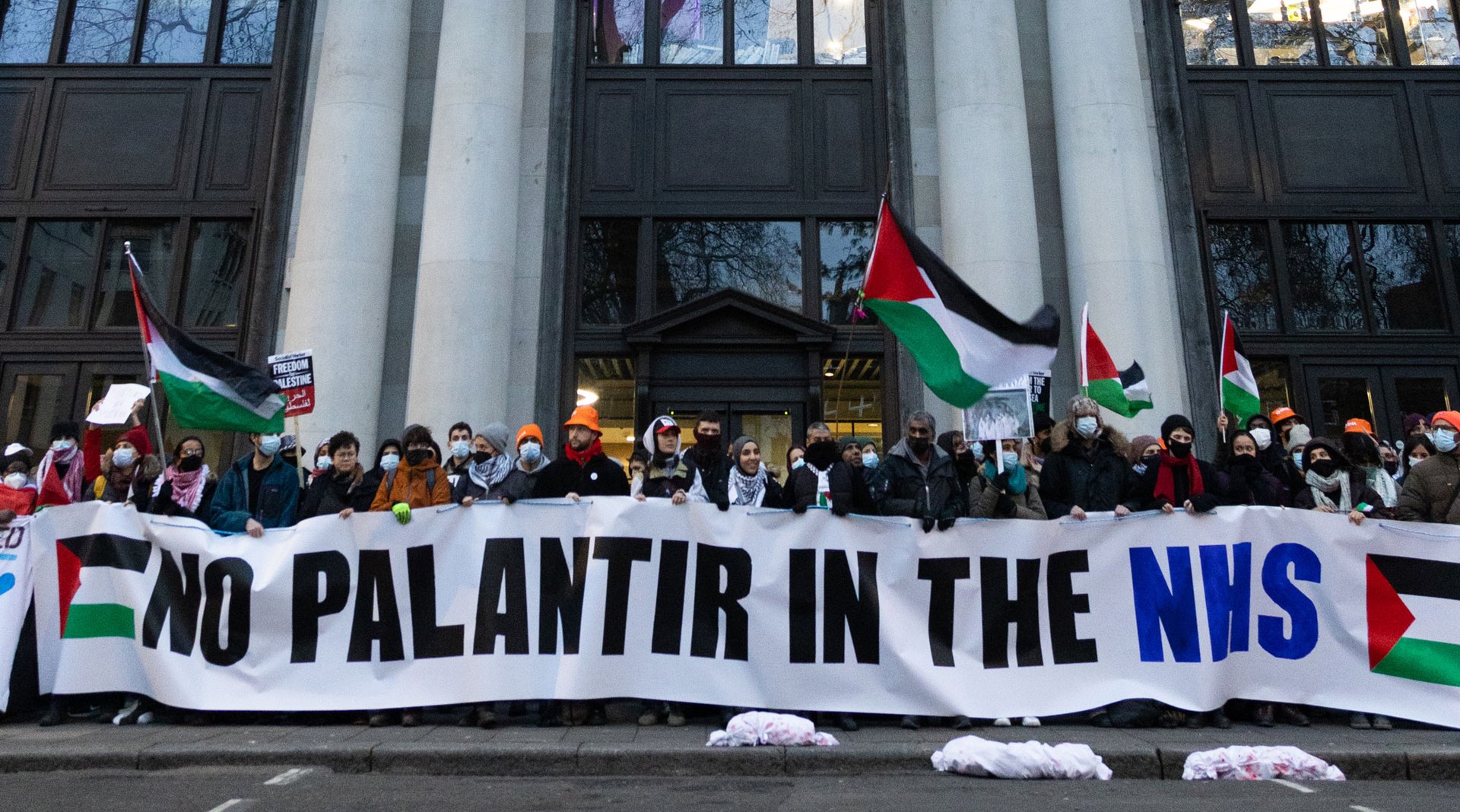 People holding a banner that reads No Palantir in the NHS