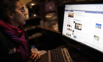 An Egyptian youth activist updates her Facebook page during the 2011 protests