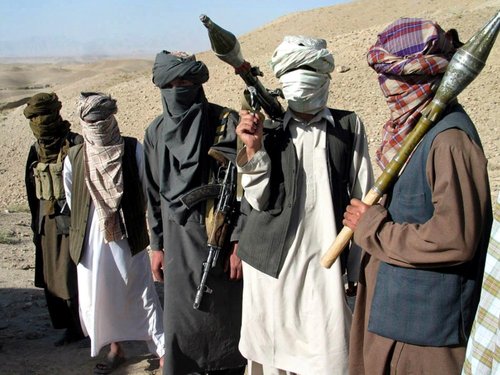 Several members of the Taliban holding rocket launchers and guns