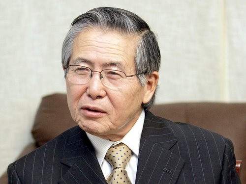 Peru's former President Alberto Fujimori answers a question during an interview with The Associated Press at his private residence