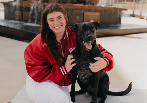 Abby from Amnesty Feminists posing with a dog