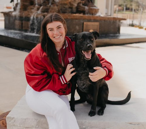 Abby from Amnesty Feminists posing with a dog
