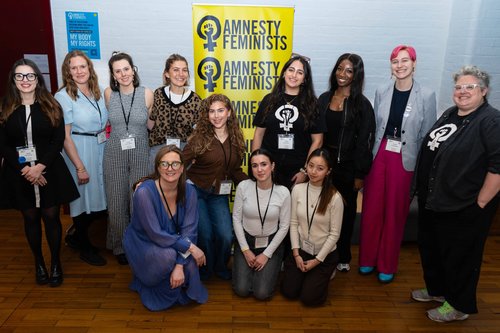 Four members of feminist network at a stall at an event