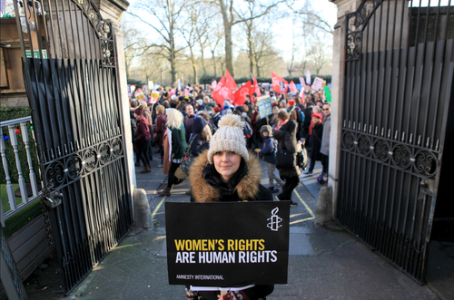 Amnesty members outside a gate