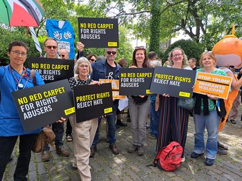 Amnesty Scotland activists holding placards at a protest