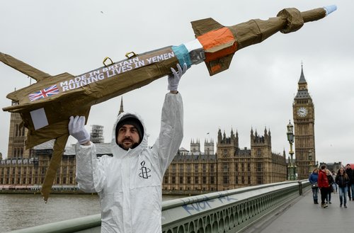 Amnesty International activists march with homemade replica missiles across Westminster Bridge