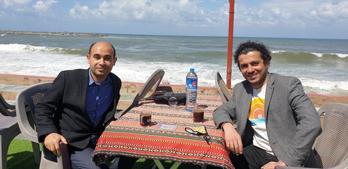 Ahmed Masoud (right) with writer Mahmoud Jouda at Gaza's Maldives cafe