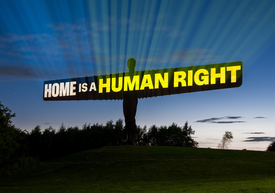 Angel of the North with 'Home is a human right' projected on to it