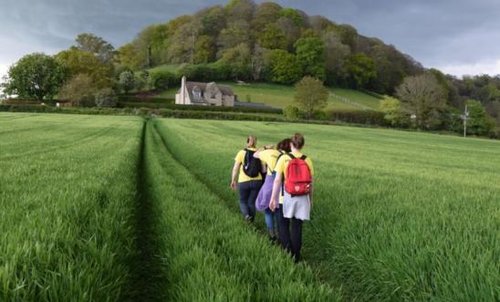 Supporters trekking through a field