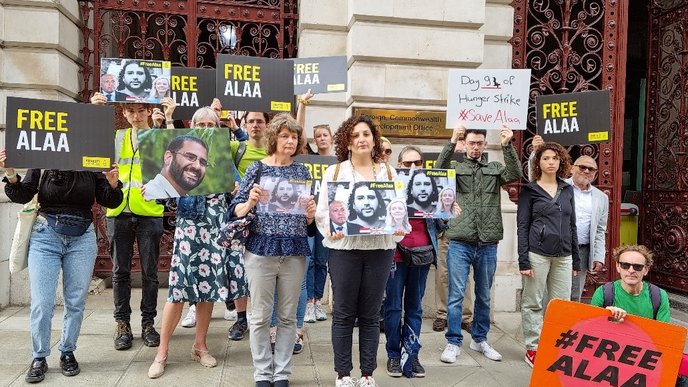 Group of people holding Free Alaa placards