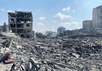 Damage of Israeli airstrikes in Gaza, with the rubble of several buildings covering the ground