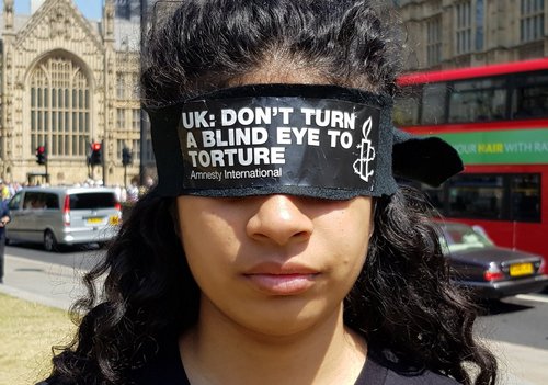 Blindfolded campaigners protest outside Parliament to call for a proper inquiry into UK torture involvement