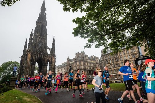 Image shows people running in Edinburgh.