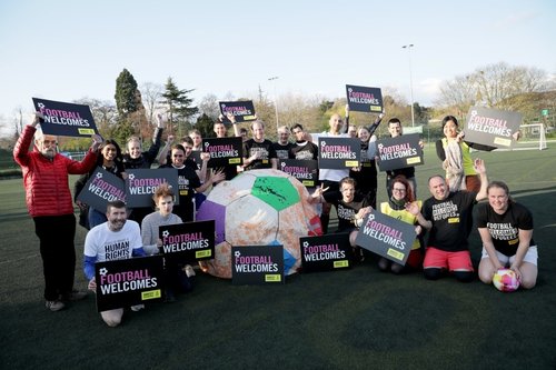 Picture shows activists with Football Welcomes banners and placards