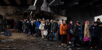 People stand beneath a bridge in Ukraine
