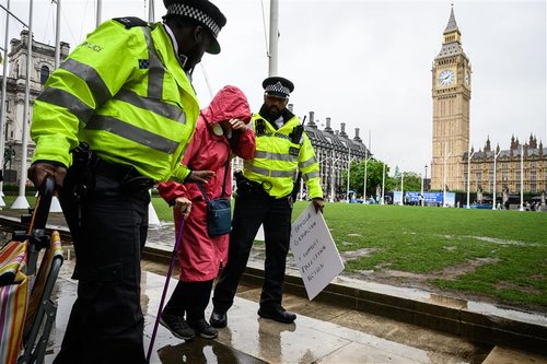 Protester being taken away by police